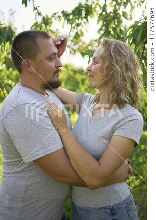 a middle-aged couple in love in the garden a middle-aged couple in love in the garden 117577693