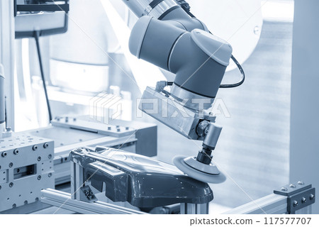 The automotive parts polishing process by robotic system in the light blue scene. 117577707