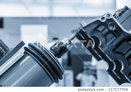 Closeup scene the milling spindle attached on the robotic arm finish cut the aluminum gear case. 117577709