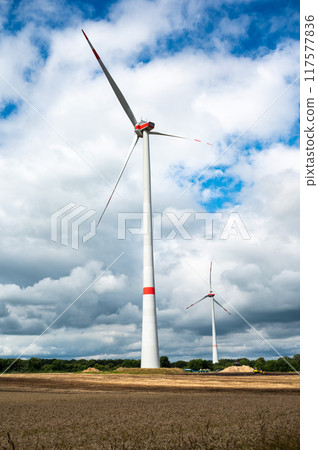 Golden wehat fields and energy generation by wind mills at the German countryside, Bredenau, Lower Saxony, Germany 117577836