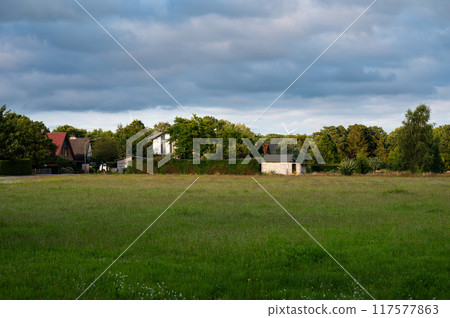 Green fields and houses at the German countryside in Heidenau, Lower Saxony, Germany 117577863