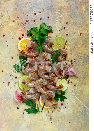 raw shrimp on skewers, shrimp kebabs, slices of lime and lemon, spices and herbs, top view, without people, raw shrimp on skewers, shrimp kebabs, slices of lime and lemon, spices and herbs, top view, without people, 117578085