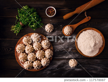 Raw khinkali, Traditional Georgian dish, on a wooden table, selective focus, rustic, no people 117578087