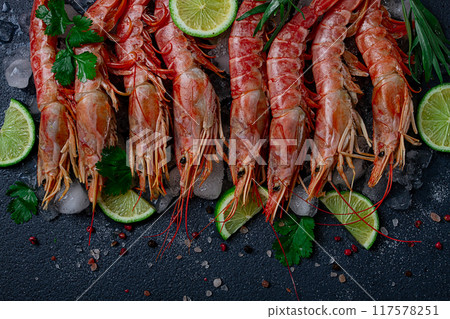 Langoustines, Australian, freshly frozen on ice, top view, lime and greens, 117578251