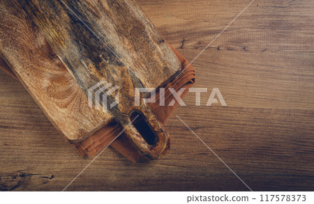 square, chopping wooden board, chopping board with handle, on a kitchen towel, rustic style, top view, no people, 117578373