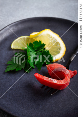 chum salmon, cold smoked, on a fork, with lemon and parsley, top view, close-up, no people, chum salmon, cold smoked, on a fork, with lemon and parsley, top view, close-up, no people, 117578378