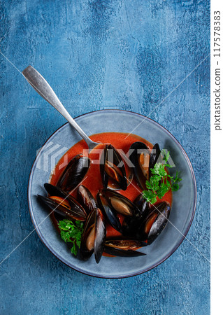 Fra Diavolo mussels, mussels in tomato sauce, Italian dish, on a blue background, homemade, no people, Fra Diavolo mussels, mussels in tomato sauce, Italian dish, on a blue background, homemade, no people, 117578383