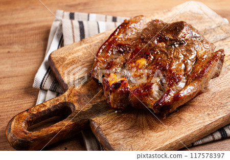 fried steak, veal neck on the bone, cooking meat, on a wooden board, top view, no people, 117578397