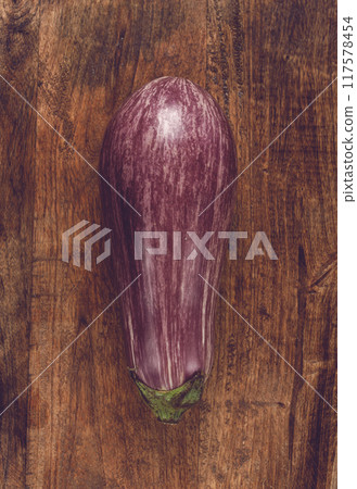 purple and white eggplant, on a wooden chopping board, top view, raw eggplant, no people, 117578454