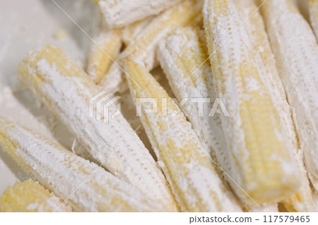 Young corn coated with flour Young corn coated with flour 117579465