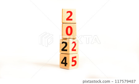 Business concept of 2025 new year symbol. Beautiful turned wooden cube and changed number 2024 to 2025. Beautiful white table white background, copy space. Business 2025 happy new year concept. Business concept of 2025 new year symbol. Beautiful turned wooden cube and changed number 2024 to 2025. Beautiful white table white background, copy space. Business 2025 happy new year concept. 117579487