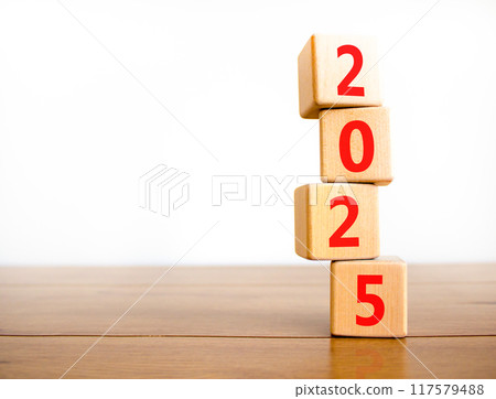 Business concept of 2025 new year symbol. Beautiful turned wooden cube and changed number 2024 to 2025. Beautiful wooden table white background, copy space. Business 2025 happy new year concept. Business concept of 2025 new year symbol. Beautiful turned wooden cube and changed number 2024 to 2025. Beautiful wooden table white background, copy space. Business 2025 happy new year concept. 117579488