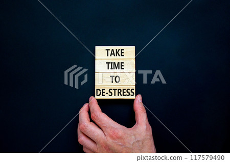 Take time to de-stress symbol. Concept words Take time to de-stress on wooden blocks. Beautiful black table black background. Psychological business and take time to de-stress concept. Copy space. 117579490