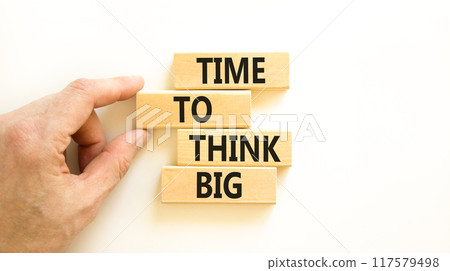 Time to think big symbol. Concept words Time to think big on beautiful wooden block. Beautiful white table white background. Businessman hand. Business and time to think big concept. Copy space. Time to think big symbol. Concept words Time to think big on beautiful wooden block. Beautiful white table white background. Businessman hand. Business and time to think big concept. Copy space. 117579498
