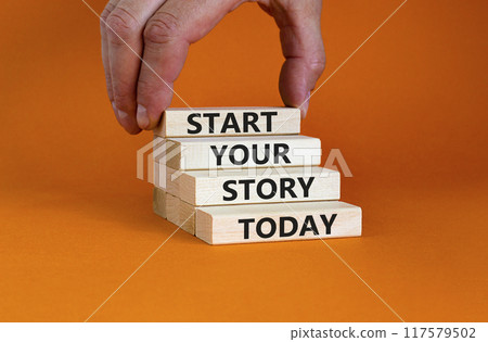 Start your story today symbol. Concept words Start your story today on wooden blocks. Businessman hand. Beautiful orange table orange background. Start your story today business concept. Copy space. Start your story today symbol. Concept words Start your story today on wooden blocks. Businessman hand. Beautiful orange table orange background. Start your story today business concept. Copy space. 117579502