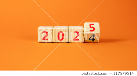 Business concept of 2025 new year symbol. Beautiful turned wooden cube and changed number 2024 to 2025. Beautiful orange table orange background, copy space. Business 2025 happy new year concept. Business concept of 2025 new year symbol. Beautiful turned wooden cube and changed number 2024 to 2025. Beautiful orange table orange background, copy space. Business 2025 happy new year concept. 117579514