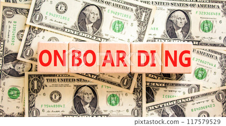 Onboarding success symbol. Concept word Onboarding on wooden blocks. Dollar bills. Beautiful background from dollar bills. Business onboarding success concept. Copy space. 117579529