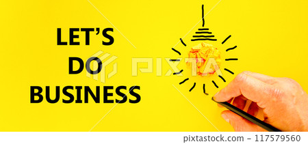 let is do business symbol. Concept words let is do business on beautiful yellow paper. Beautiful yellow background. Light bulb icon. Businessman hand. let is do business concept. Copy space. 117579560