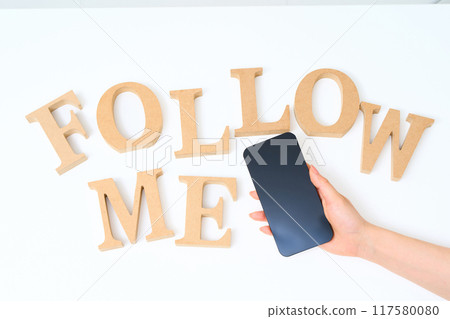 Wooden alphabet blocks arranged with the word "FOLLOW ME" Wooden alphabet blocks arranged with the word "FOLLOW ME" 117580080
