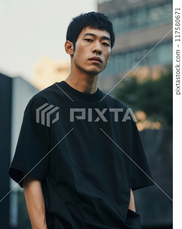 An Asian male model wearing a black heavyweight cotton small neckline oversize basic T-shir An Asian male model wearing a black heavyweight cotton small neckline oversize basic T-shir 117580671