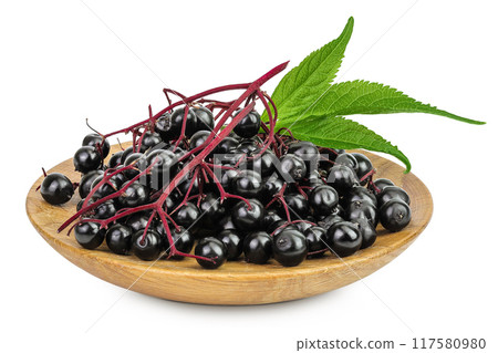 Ripe black elderberry or elder with green leaves in wooden bowl isolated on a white background. Sambucus Ripe black elderberry or elder with green leaves in wooden bowl isolated on a white background. Sambucus 117580980
