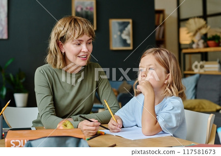 Young beautiful Caucasian mom smiling and waiting for her daughter who thinking about sketch idea Young beautiful Caucasian mom smiling and waiting for her daughter who thinking about sketch idea 117581673