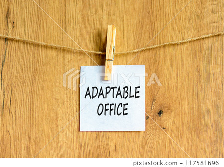 Adaptable office symbol. Concept words Adaptable office on beautiful white paper on wooden clothespin. Beautiful wooden background. Business Adaptable office concept. Copy space. Adaptable office symbol. Concept words Adaptable office on beautiful white paper on wooden clothespin. Beautiful wooden background. Business Adaptable office concept. Copy space. 117581696