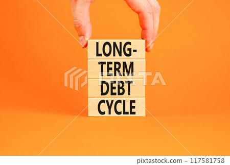 Long-term debt cycle symbol. Concept words Long-term debt cycle on beautiful wooden block. Beautiful orange table orange background. Businessman hand. Business Long-term debt cycle concept. Copy space 117581758