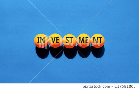 Investment symbol. Concept word Investment on beautiful yellow ping pong balls. Beautiful blue background. Business investment concept. Copy space. Investment symbol. Concept word Investment on beautiful yellow ping pong balls. Beautiful blue background. Business investment concept. Copy space. 117581803