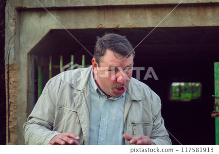 Twisted, Angry Man Exits Abandoned Tunnel, Eyes Filled with Rage, Portraying a Maniacal Figure Ready to Confront Viewer in a Creepy Setting. 117581913