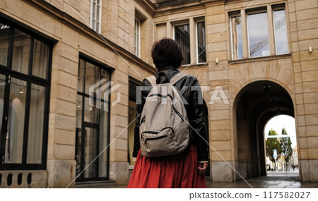 Attractive Woman Walks In City With Backpack, Looking Around Attractive Woman Walks In City With Backpack, Looking Around 117582027