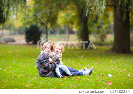 Kids play in autumn park Kids play in autumn park 117582224