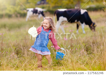Kids watch cow on dairy farm 117582246