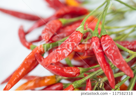 Image of dried red chili peppers on a table 117582318