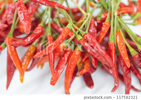 Image of dried red chili peppers on a table 117582321