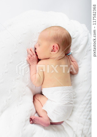 Newborn baby boy in hospital cot 117582368