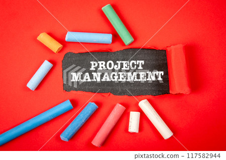 Project management. Text under torn red paper on a blackboard 117582944
