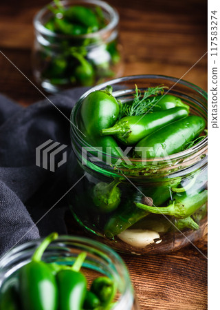 Canned Jalapeno Peppers, Garlic And Dill in Glass Jars Canned Jalapeno Peppers, Garlic And Dill in Glass Jars 117583274