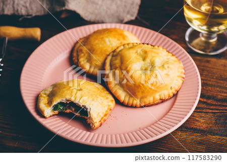 Oven Baked Pastries with Blue Chives and Mushrooms. One with Bite Taken Out of It Oven Baked Pastries with Blue Chives and Mushrooms. One with Bite Taken Out of It 117583290