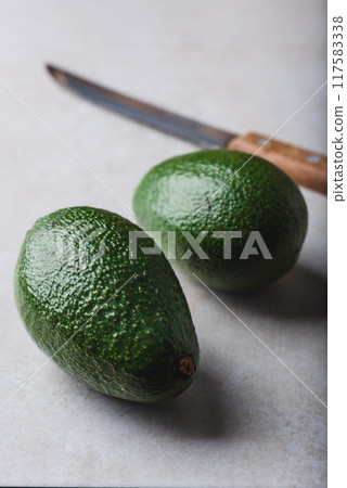Green avocados on the table Green avocados on the table 117583338