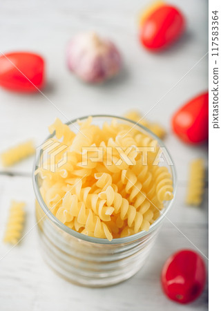 Italian fusilli pasta in glass bowl Italian fusilli pasta in glass bowl 117583364