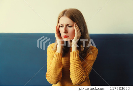 Exhausted tired woman suffering from headache, stress, fatigue, temples pain, migraine, loud noise 117583633