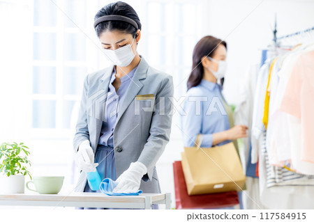 Staff wearing masks cleaning 117584915
