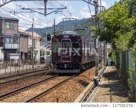 Nose Electric Railway train running through a densely populated residential area 117585250