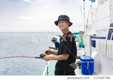 A man enjoying sea fishing A man enjoying sea fishing 117585706