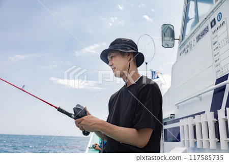 A man enjoying sea fishing A man enjoying sea fishing 117585735