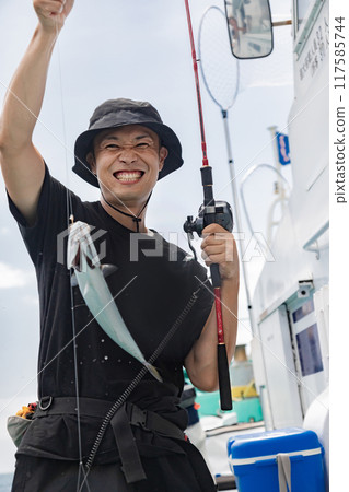 A man enjoying sea fishing A man enjoying sea fishing 117585744