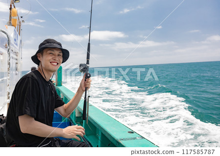 A man enjoying sea fishing A man enjoying sea fishing 117585787