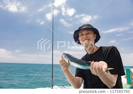 A man enjoying sea fishing A man enjoying sea fishing 117585793