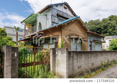 A vacant two-story house damaged by the elements A vacant two-story house damaged by the elements 117586520